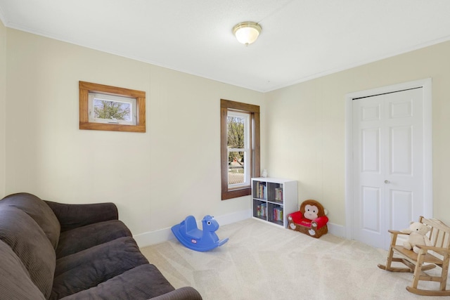 sitting room with carpet, baseboards, and ornamental molding