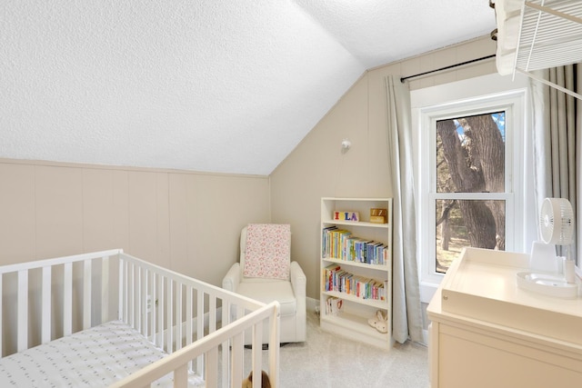 bedroom featuring vaulted ceiling, light colored carpet, a nursery area, and multiple windows