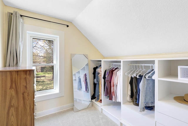 walk in closet featuring vaulted ceiling and carpet floors