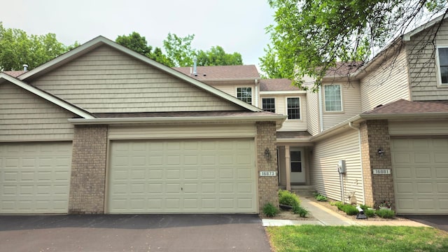 16873 79th Ave N, Maple Grove, MN 55311 - view of front of home with brick siding, driveway, and an attached garage