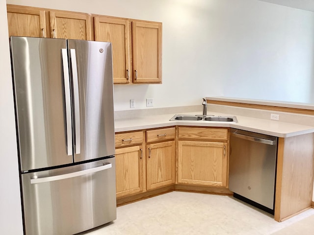 16873 79th Ave N, Maple Grove, MN 55311 - kitchen featuring appliances with stainless steel finishes, a sink, light brown cabinetry, a peninsula, and light countertops