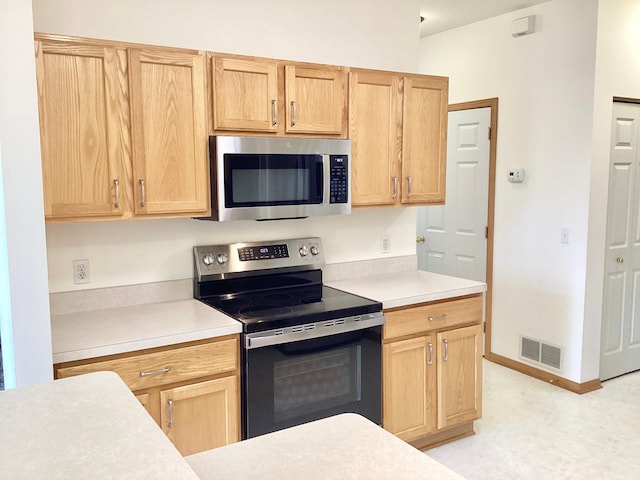 16873 79th Ave N, Maple Grove, MN 55311 - kitchen featuring stainless steel appliances, light brown cabinetry, and light countertops