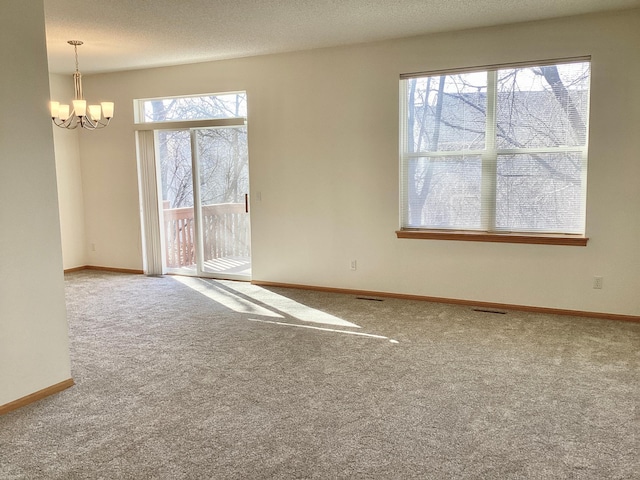 16873 79th Ave N, Maple Grove, MN 55311 - empty room with carpet flooring, a chandelier, and baseboards