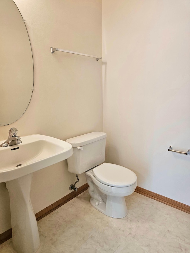 16873 79th Ave N, Maple Grove, MN 55311 - half bathroom featuring toilet, baseboards, and a sink
