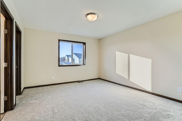 unfurnished bedroom with carpet flooring and baseboards