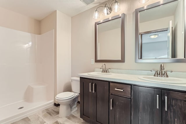 full bathroom featuring a sink, toilet, double vanity, and a shower