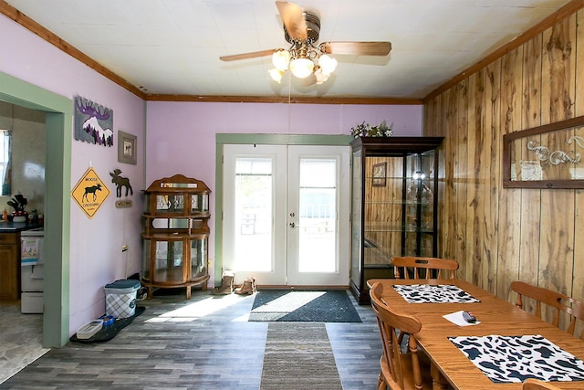 doorway to outside featuring french doors, a wealth of natural light, ceiling fan, wood walls, and wood finished floors