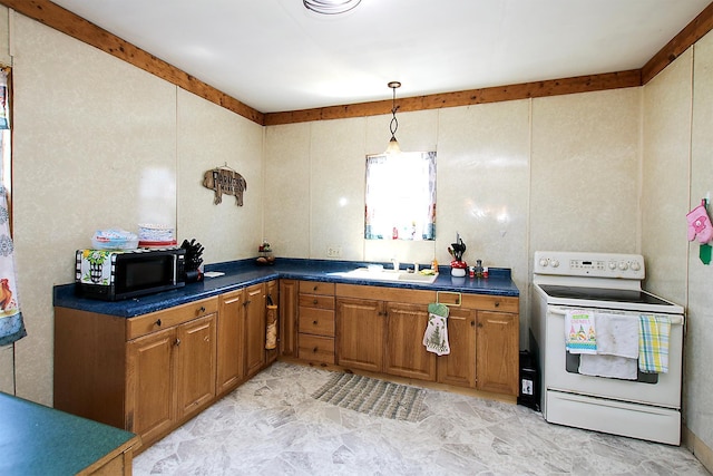 kitchen with a sink, black microwave, dark countertops, and electric stove