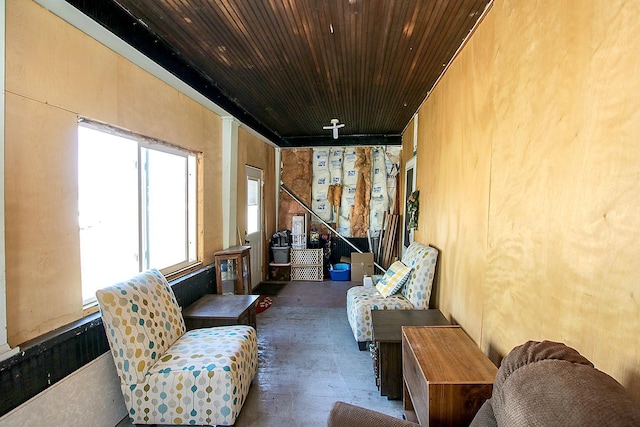 interior space featuring wood ceiling and concrete floors