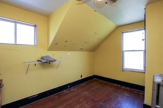 additional living space featuring hardwood / wood-style floors, ceiling fan, and vaulted ceiling