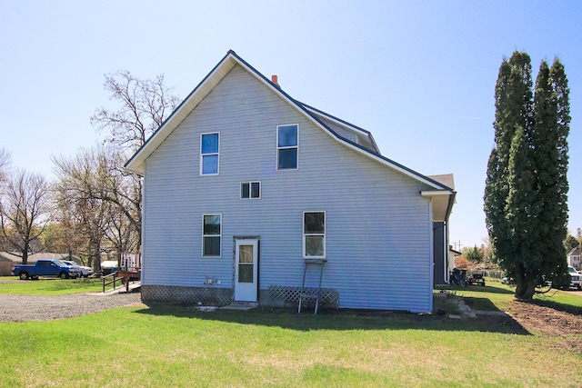 rear view of house with a yard