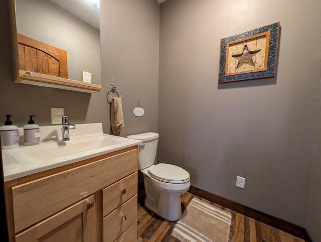36861 477th Ave, Otto Twp, MN 56567 - half bathroom featuring toilet, vanity, wood finished floors, and baseboards
