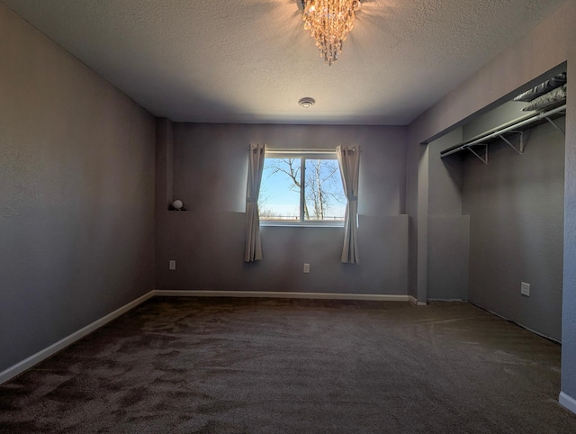 36861 477th Ave, Otto Twp, MN 56567 - unfurnished bedroom featuring carpet flooring, a textured ceiling, a chandelier, and baseboards
