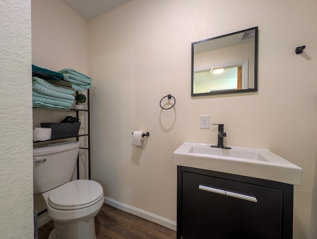 36861 477th Ave, Otto Twp, MN 56567 - half bathroom with vanity, toilet, wood finished floors, and baseboards