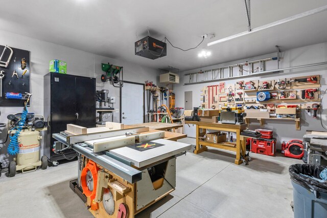 garage featuring a garage door opener, electric panel, and a workshop area