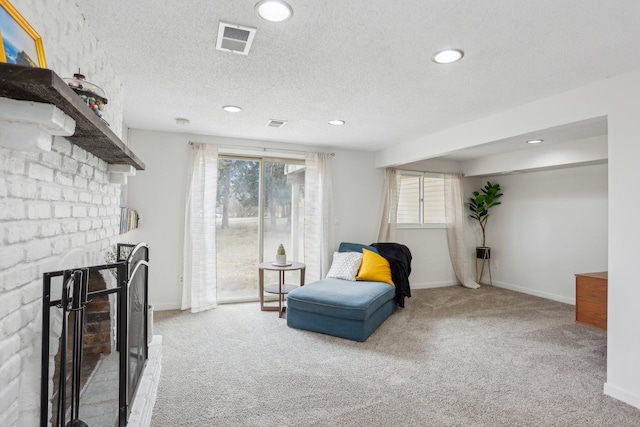 living area with visible vents, a brick fireplace, carpet flooring, and recessed lighting