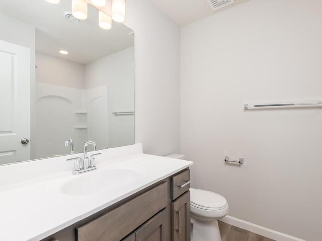 539 Winkler Trl N, Cologne, MN 55322 - full bath featuring toilet, wood finished floors, vanity, and baseboards