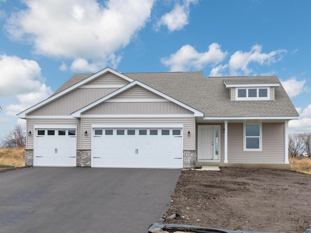 539 Winkler Trl N, Cologne, MN 55322 - view of front of house with an attached garage, a shingled roof, stone siding, and aphalt driveway