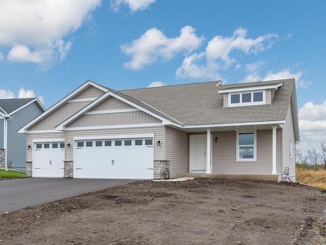 539 Winkler Trl N, Cologne, MN 55322 - view of front of house with concrete driveway, stone siding, a garage, and a shingled roof