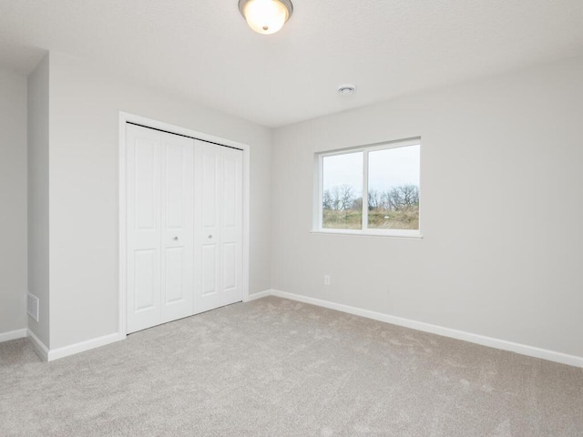 539 Winkler Trl N, Cologne, MN 55322 - unfurnished bedroom featuring a closet, baseboards, carpet flooring, and visible vents