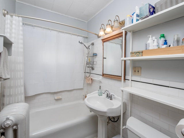 full bath featuring crown molding, shower / bath combination with curtain, toilet, and tile walls
