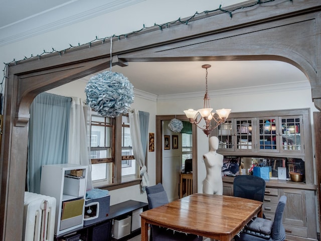 dining area featuring crown molding, arched walkways, a notable chandelier, and radiator
