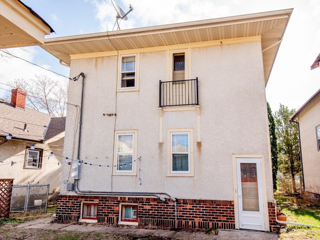 back of house with fence and stucco siding