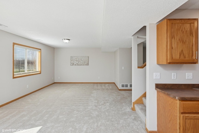 128 Oakmont Ln, Red Wing, MN 55066 - unfurnished living room with stairs, light colored carpet, and baseboards