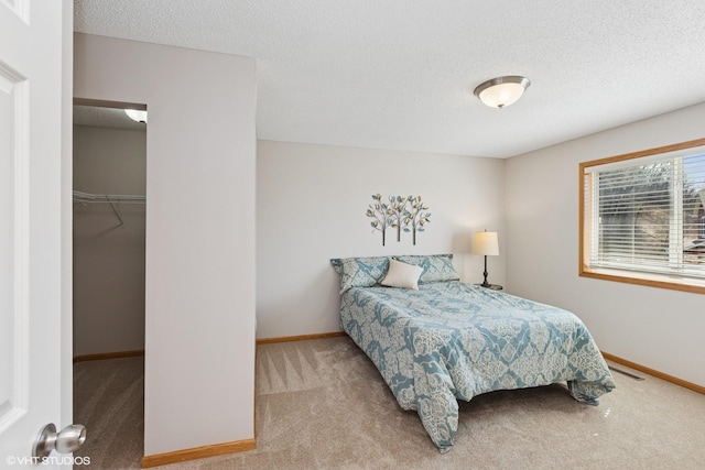 128 Oakmont Ln, Red Wing, MN 55066 - bedroom with carpet floors, a textured ceiling, a spacious closet, baseboards, and a closet