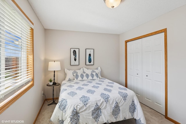 128 Oakmont Ln, Red Wing, MN 55066 - bedroom featuring light carpet, multiple windows, a closet, and baseboards