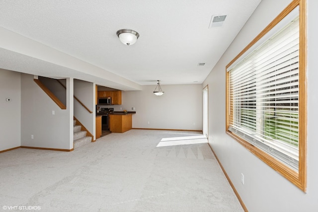 128 Oakmont Ln, Red Wing, MN 55066 - unfurnished living room with light carpet, baseboards, and stairway