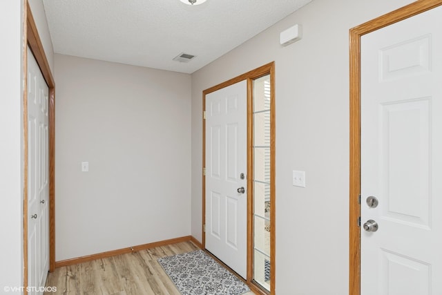 128 Oakmont Ln, Red Wing, MN 55066 - entryway with light wood-type flooring, baseboards, and a textured ceiling