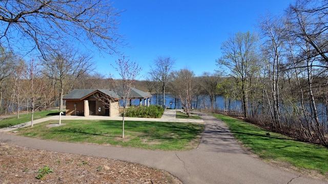 view of home's community featuring a yard and driveway