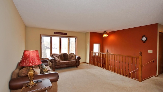 carpeted living room featuring ceiling fan