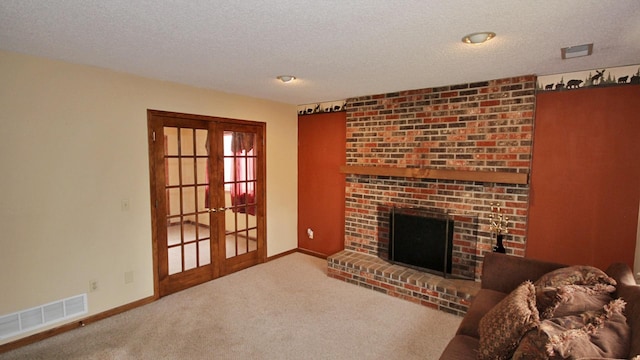 living room featuring carpet floors, a textured ceiling, french doors, baseboards, and visible vents