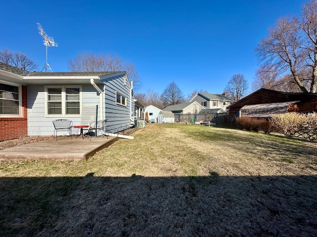view of yard with a deck and fence