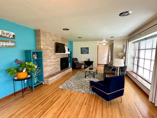 living area featuring a fireplace and wood finished floors
