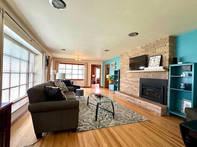 living room featuring wood finished floors and a brick fireplace