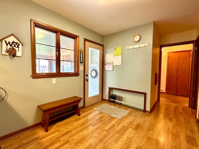 entryway with light wood-style flooring and baseboards