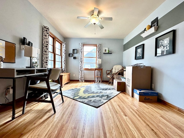 office featuring wood finished floors, ceiling fan, and baseboards