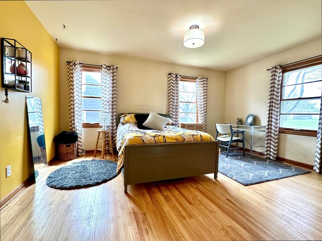 bedroom with wood finished floors and baseboards