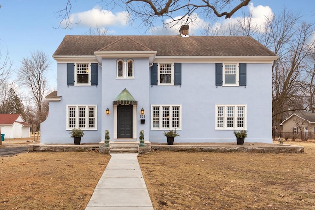 525 Main St, Owatonna, MN 55060 - colonial inspired home with stucco siding and a chimney