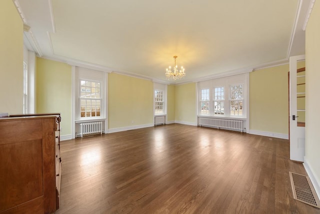 525 Main St, Owatonna, MN 55060 - unfurnished living room with a chandelier, visible vents, dark wood-style flooring, and radiator