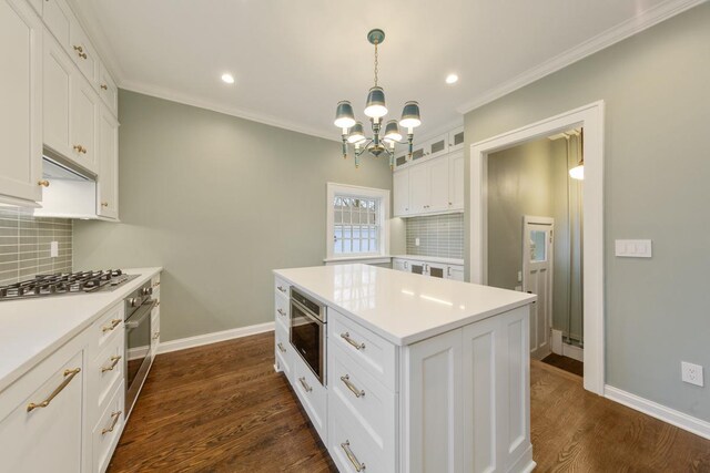 525 Main St, Owatonna, MN 55060 - kitchen with a chandelier, white cabinetry, appliances with stainless steel finishes, and backsplash