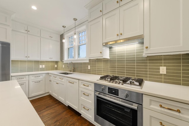 525 Main St, Owatonna, MN 55060 - kitchen with stainless steel appliances, under cabinet range hood, light countertops, and a sink