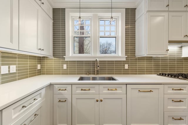 525 Main St, Owatonna, MN 55060 - kitchen featuring a sink, light countertops, white cabinets, and backsplash