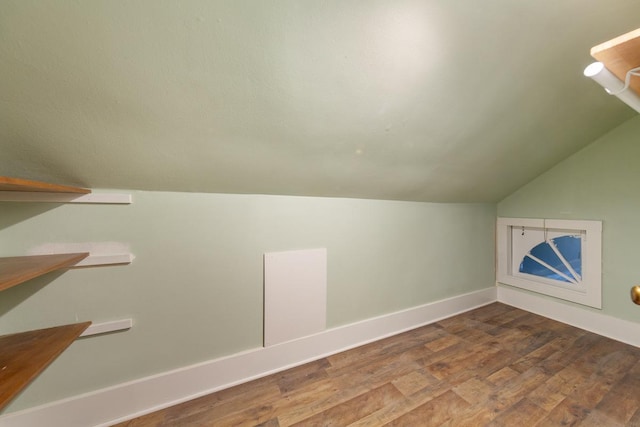 525 Main St, Owatonna, MN 55060 - bonus room featuring dark wood-style flooring, baseboards, and lofted ceiling