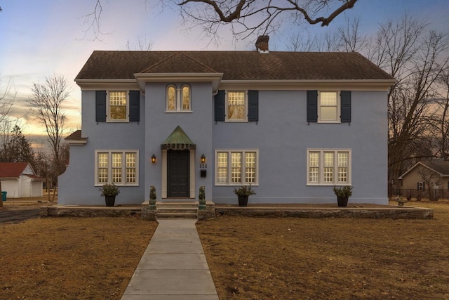 525 Main St, Owatonna, MN 55060 - colonial inspired home featuring roof with shingles, a chimney, and stucco siding