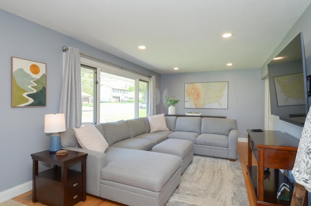 living area with recessed lighting, light wood finished floors, and baseboards