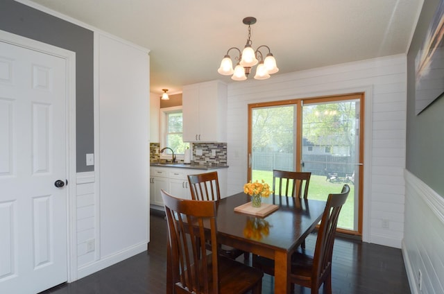 dining space with a chandelier and dark wood-type flooring